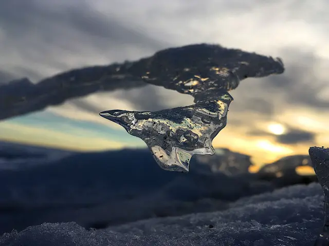 Ice formation on a frozen beach at sunset